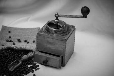roasted coffee beans and a vintage coffee grinderの写真素材
