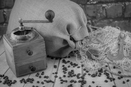 roasted coffee beans and a vintage coffee grinderの写真素材