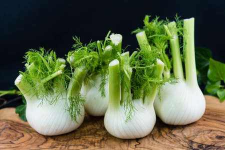 green and white fennel bulbs on olive woodの写真素材
