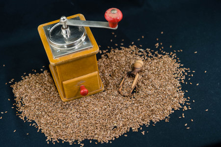 a pile of flaxseeds and utensils made of olive woodの写真素材