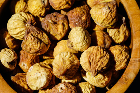 sweet dried figs in an olive wood bowlの写真素材