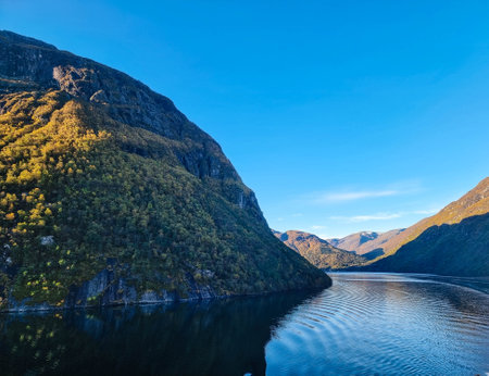 With a cruise ship in the fjords of norwayの写真素材