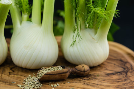 green and white fennel bulbs on olive woodの写真素材