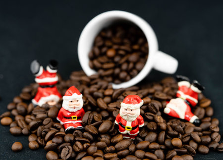 Santa Claus is sitting amid brown roasted coffee beansの写真素材