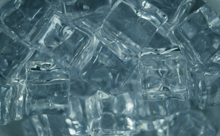 diffuse light shines on a handful of ice cubesの写真素材