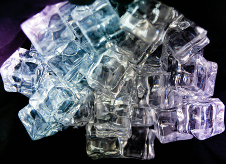 diffuse light shines on a handful of ice cubes