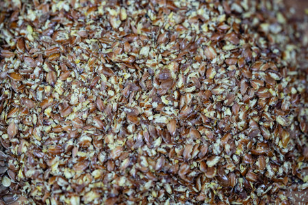 a pile of flaxseeds Linum usitatissimum on olive wood