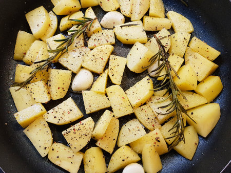 roasted potatoes with bacon onions and spicesの写真素材