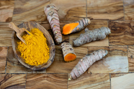 Turmeric Curcuma longa the yellow spice on olive woodの写真素材