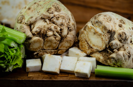Fresh celery Apium graveolens on olive wood