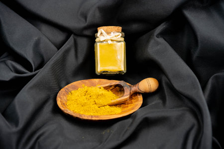 cashew kernels with curry powder on olive woodの写真素材