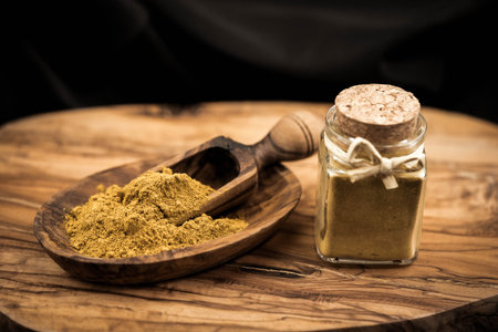 cashew kernels with curry powder on olive woodの写真素材