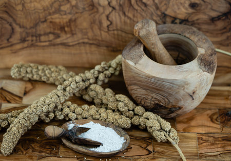Dried millet flour on olive woodの写真素材