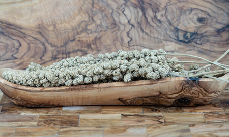 Dried millet flour on olive woodの写真素材
