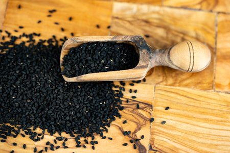 the roman coriander nigella sativa on olive wood