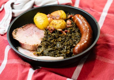 North German national dish green cabbage with roast pork, cabbage sausage and roast potatoesの写真素材