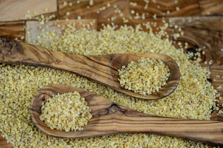 dried bulgur on olive woodの写真素材
