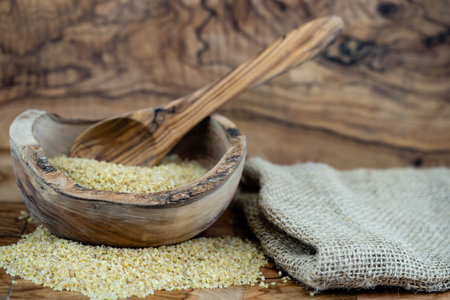 dried couscous on olive woodの写真素材