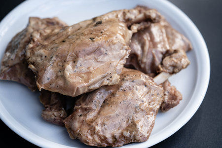 grilled pig wings - sliced open pork knuckle of a young pig with caesars salad