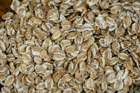 whole grain Secale cereale rye flakes on olive woodの写真素材