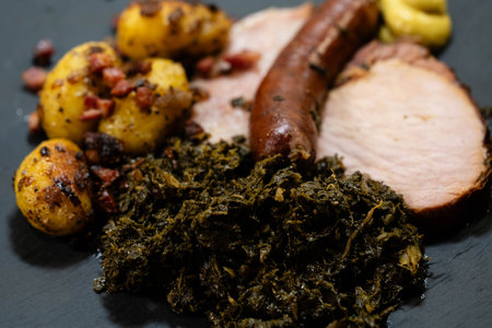 North German national dish green cabbage with roast pork, cabbage sausage and roast potatoesの写真素材