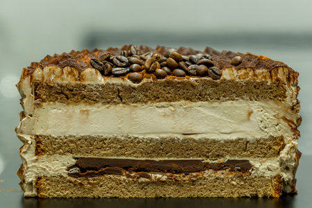 Tiramisu cake with coffee beans on top, close up