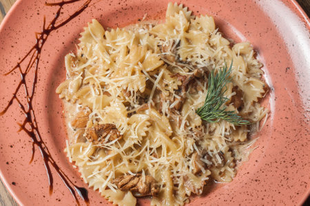 pasta with mushrooms and parmesan on a plate, top viewの写真素材