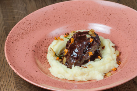 Beef Bourguignon with mashed potatoes on a pink plateの写真素材