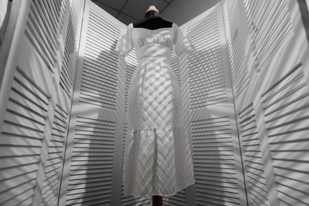 Women's white dress on a mannequin in a dressing roomの写真素材
