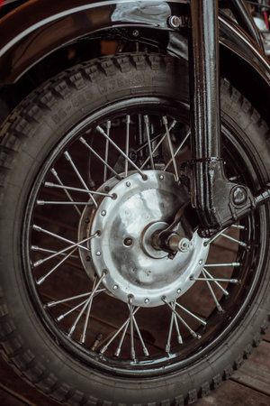 Close-up of the rear wheel of a vintage motorcycle, selective focus