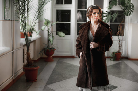 Fashionable portrait of a beautiful woman in a brown coat.の写真素材