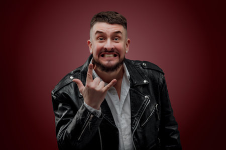Portrait of a man in a leather jacket on a red background