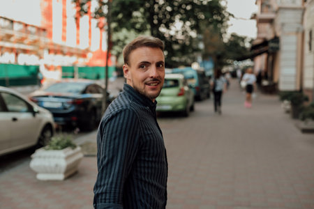 Portrait of a handsome young man with a beard on the street
