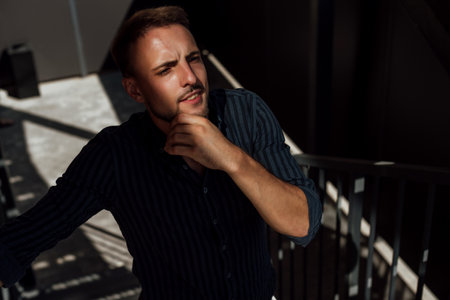Portrait of handsome young man in casual clothing looking at camera and thinking.の写真素材