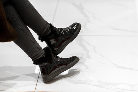 Female legs in black shoes on a white background. close-up.