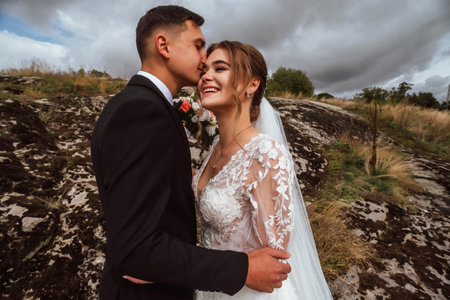 Wedding couple, bride and groom embracing on the background of beautiful landscapeの写真素材