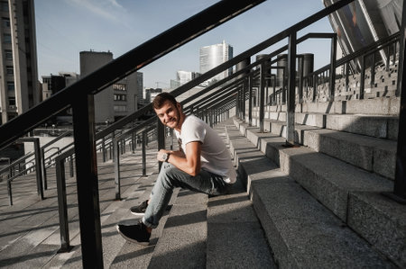 Handsome Young Man Sitting On Staircase In The City