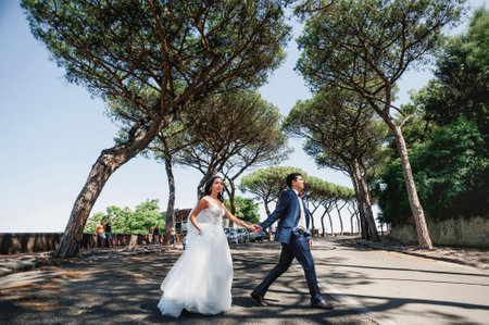 Wedding couple, bride and groom walking in the parkの写真素材