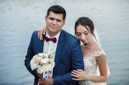Wedding couple, bride and groom on the background of the lake