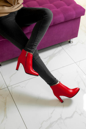 Legs of a young woman wearing red high-heeled shoesの写真素材