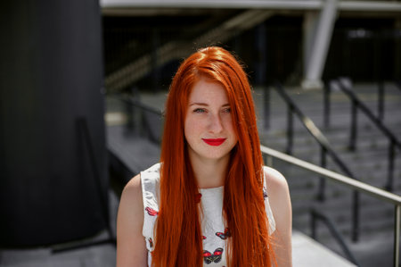 Portrait of a beautiful young redhead woman with freckles