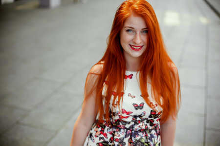 Portrait of beautiful redhead girl with long hair, outdoors.の写真素材