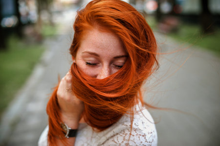 Portrait of a beautiful red-haired girl with long hair.の写真素材