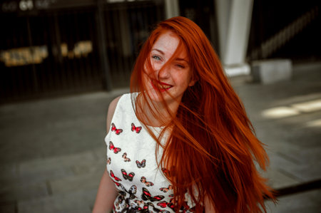 Portrait of a red-haired girl with freckles on her faceの写真素材