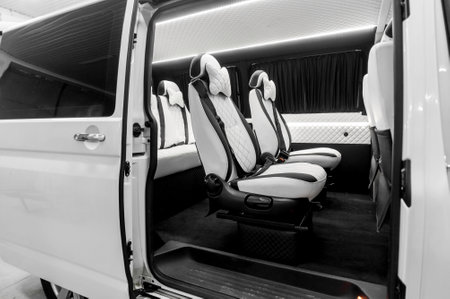 Comfortable interior of a passenger bus with soft seats. The design is made to order. Private...