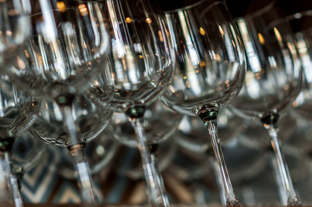 Many clear glasses for drinks. Background of glass glasses in cafe. Several empty wine glasses.
