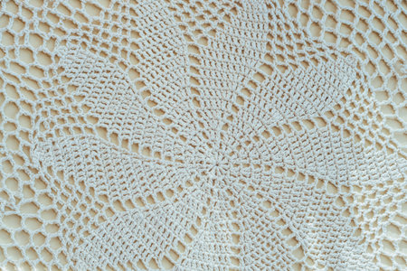 Fabric texture from woven threads with knitting needles. Knitting is the process of making products from continuous threads by bending them into a loop. Patterns using knitting technology.の写真素材