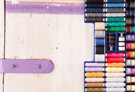 Many colorful threads on a wooden box