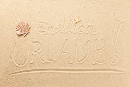 Finally Holiday written in sand