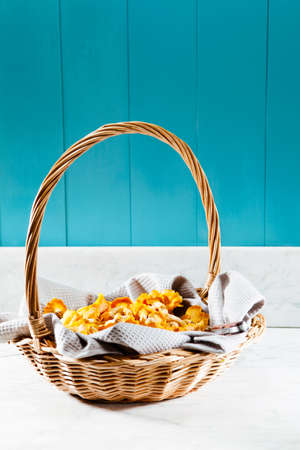 Basket of chanterelles on a Mediterranean tableの写真素材